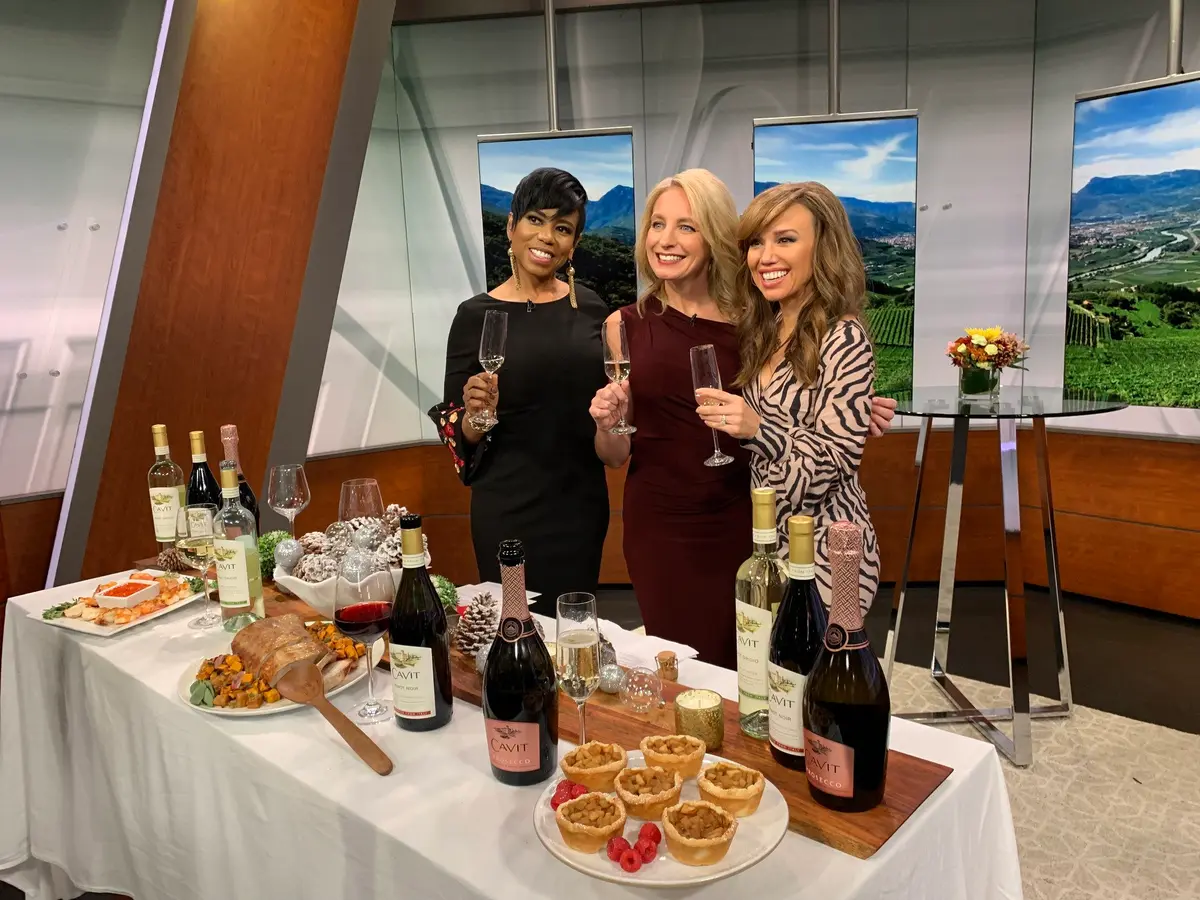 Julie Hartigan on a TV set with hosts
