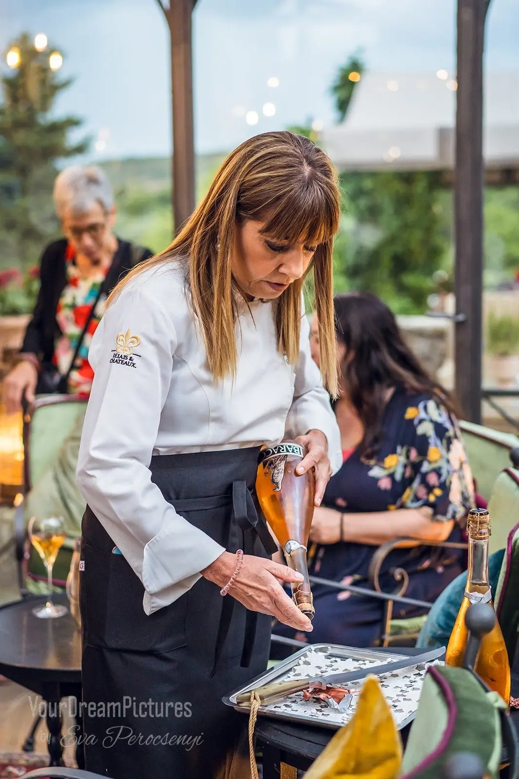 A chef sabering champagne at a group trip dinner
