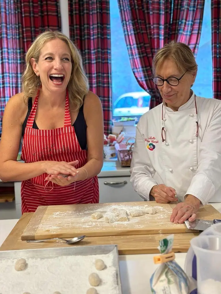 Julie Hartigan attending a cooking class with a chef