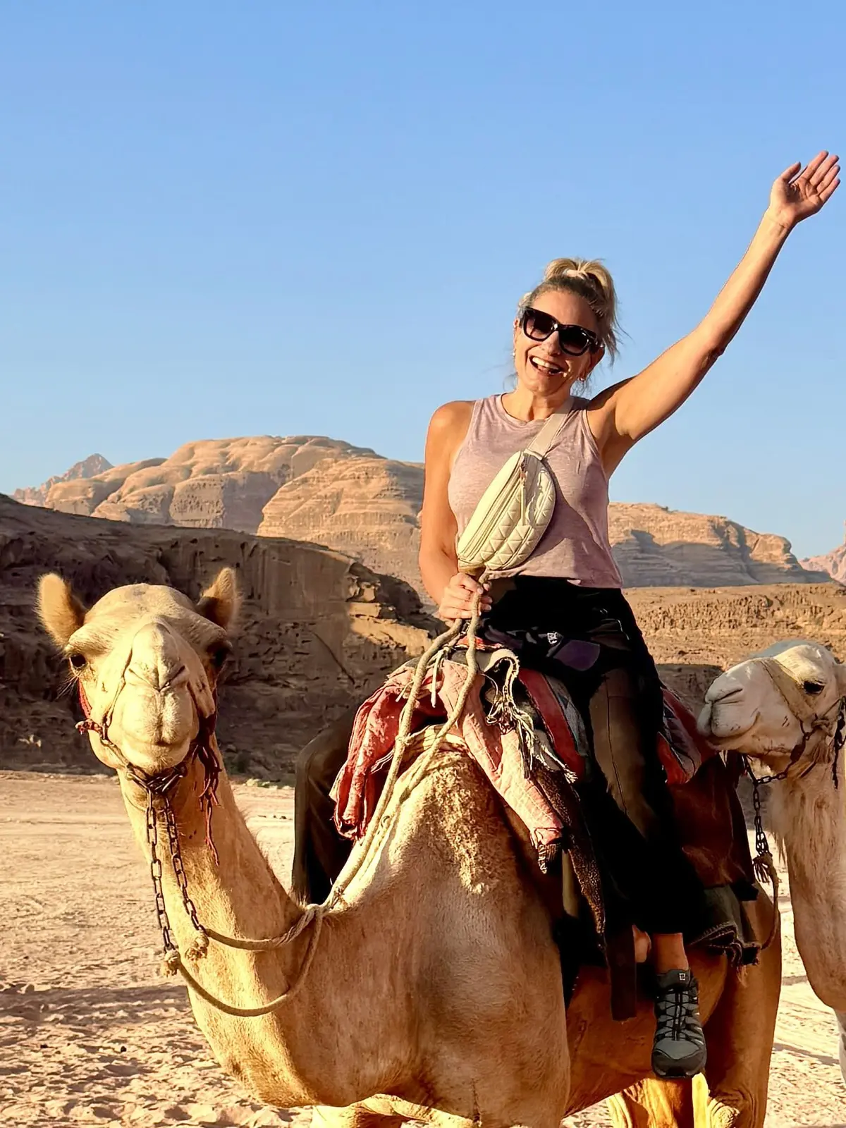 Julie Hartigan riding a camel in the desert