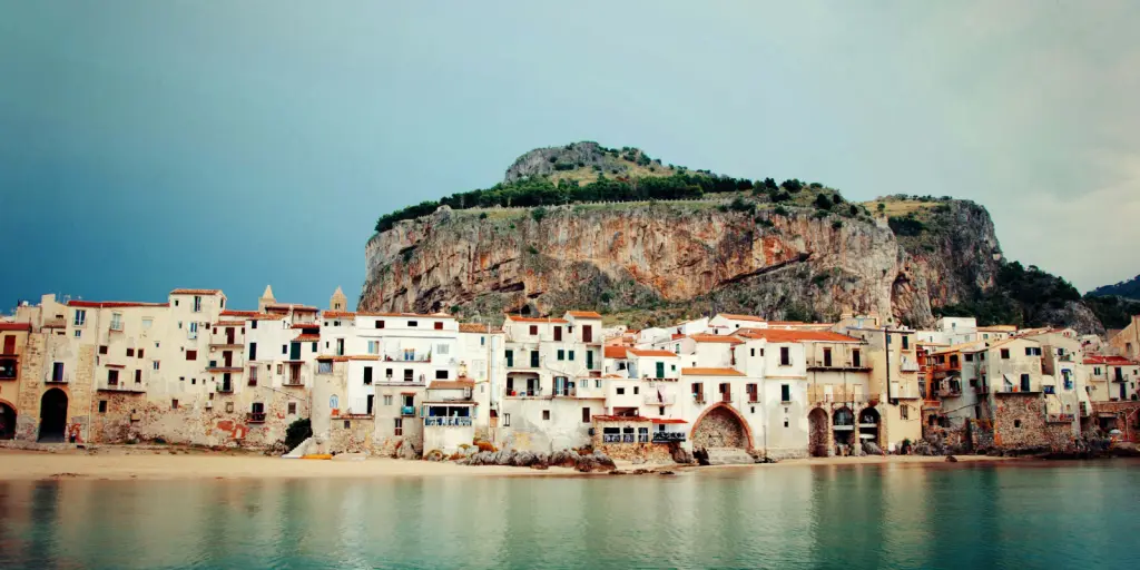 A seaside town beneath a cliff in Sicily